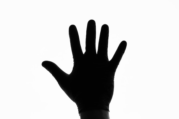 Foto silueta de la mano frente a la luz blanca