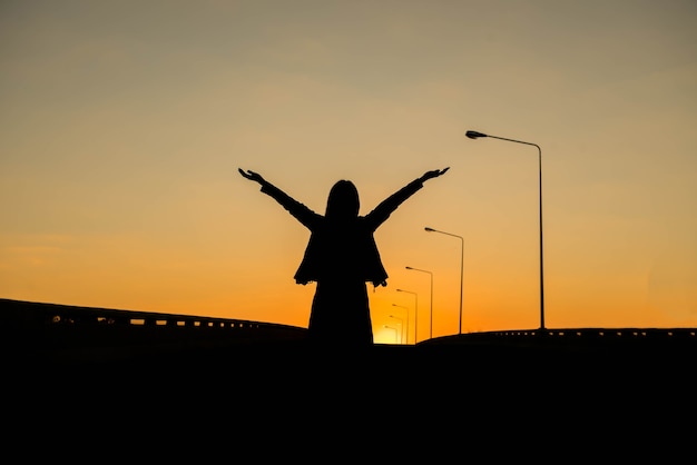 Silueta de una mujer con cielo de la tarde.