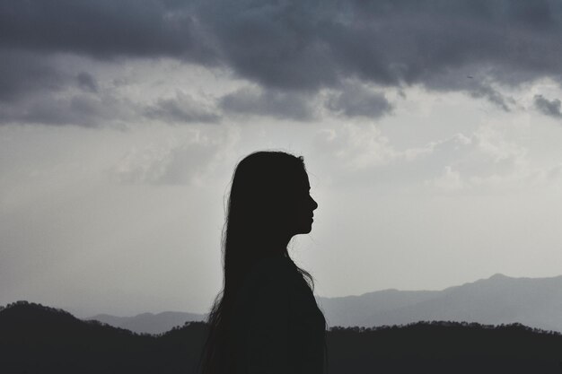 Foto la silueta de una mujer de pie contra el cielo