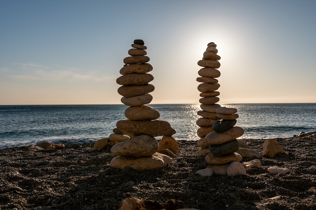 Silueta de pirámide de guijarros equilibrada en la playa