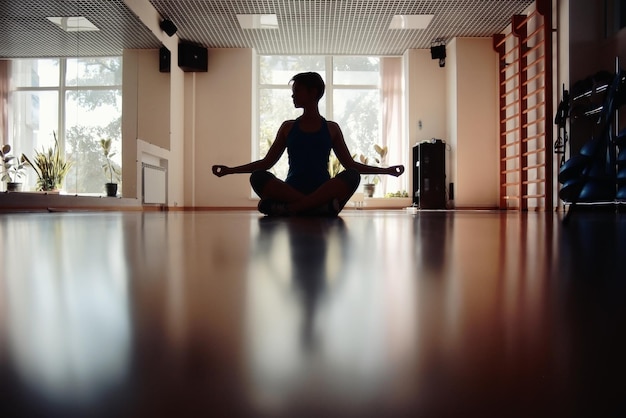 silueta de yoga de chica fitness en la habitación