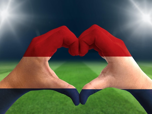 Foto símbolo de apoyo del equipo de fútbol. bandera holandesa aislada con forma de amor a mano. aficionados al fútbol