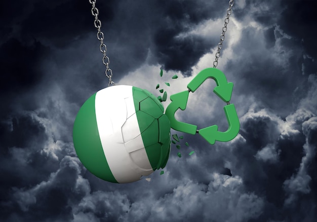 Símbolo de reciclaje verde chocando contra una representación de bola de bandera de nigeria d