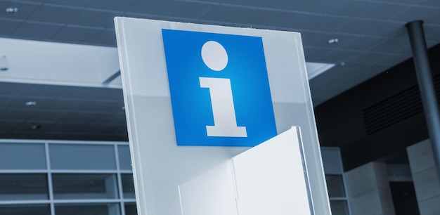Símbolo de señal de información azul en un edificio de oficinas moderno. ideal para sitios web y diseños de revistas.