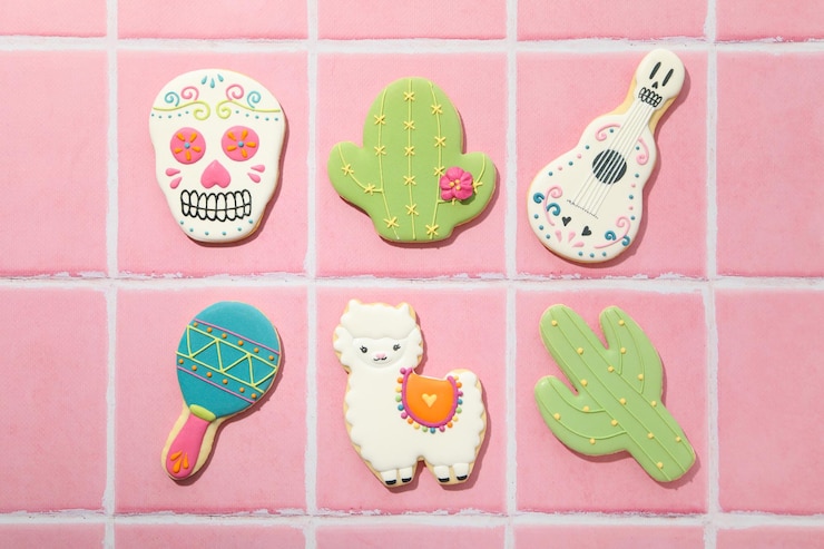 Foto símbolos mexicanos para el día de muertos sobre fondo rosa.