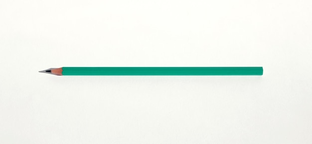 Foto un simple lápiz verde sobre un fondo blanco el concepto de crear una imagen