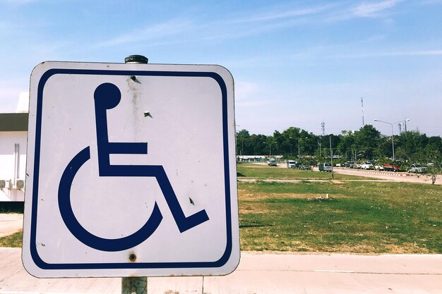 Foto sinal de estacionamento de carros com deficiência contra o céu