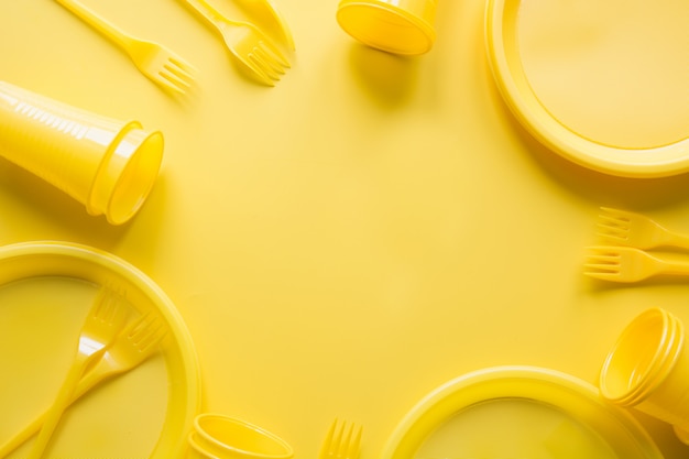 Singe use utensilios de picnic para reciclar en amarillo.