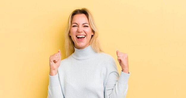 Sintiéndose sorprendido emocionado y feliz riendo y celebrando el éxito diciendo wow