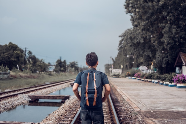 Sirva el tren que espera del backpacker en la estación de tren para viajar con tono del vintage.