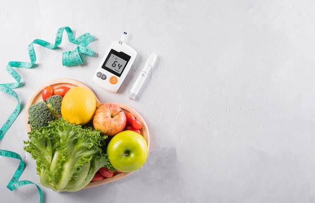 Sistema de medición diabética cinta métrica y alimentos saludables que comen nutrición en placa