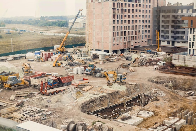 Sitio de construcción Maquinaria de construcción Bulldozer Excavación Grúas de fábrica y área de construcción de casas de arena en la ciudad