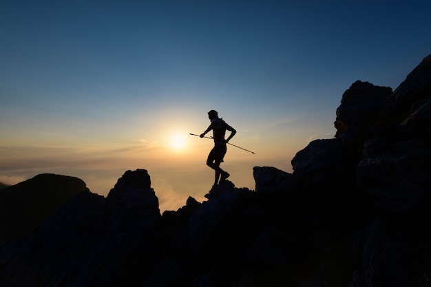 Sky Runner en silueta al atardecer entre las rocas