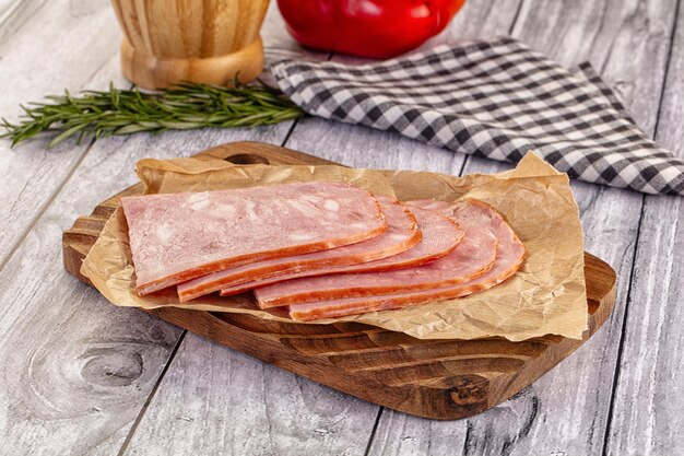 sliced porjk ham over boatd