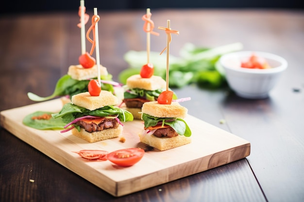 Sliders de carne com tomate e alface em uma travessa de madeira