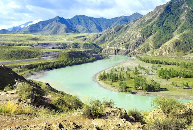 Smaragdgrünes Wasser von Bergflüssen unter felsigen Bergen unter blauem Himmel Sibirien Russland