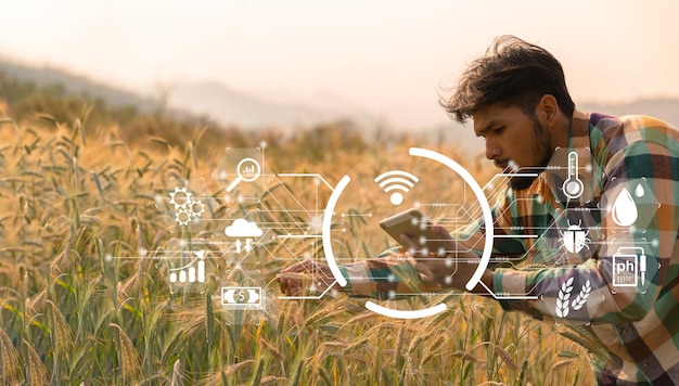 Smart-Farming-Konzept Landwirt mit digitalem Technologie-Tablet auf dem Hintergrund des Weizenfeldes Professionelle Landwirte nutzen das Internet der Dinge IOT-Computersystem, um die moderne Idee der landwirtschaftlichen Landwirtschaft zu verwalten