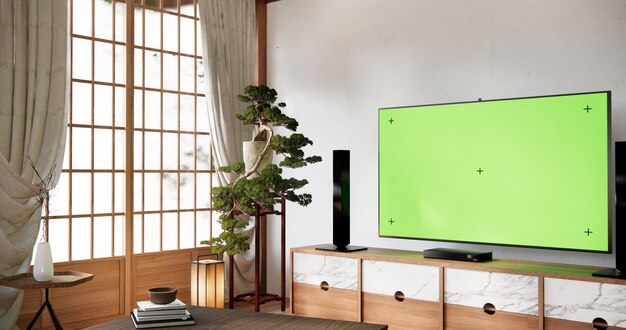 Foto smart tv mockup com tela verde em branco pendurado em modernos interiores de salas vazias brancas de design minimalista