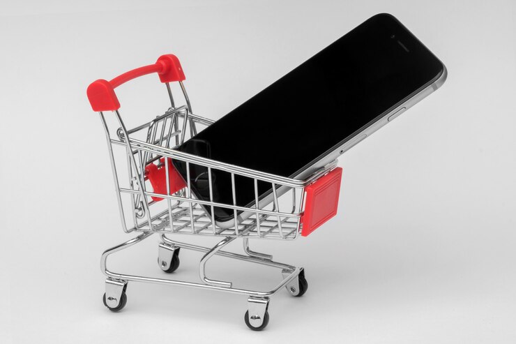Foto smartphone en un carrito de compras