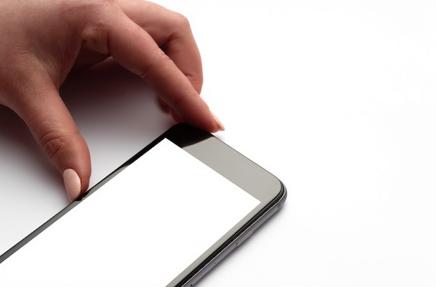 Foto smartphone com tela em branco nas mãos femininas.