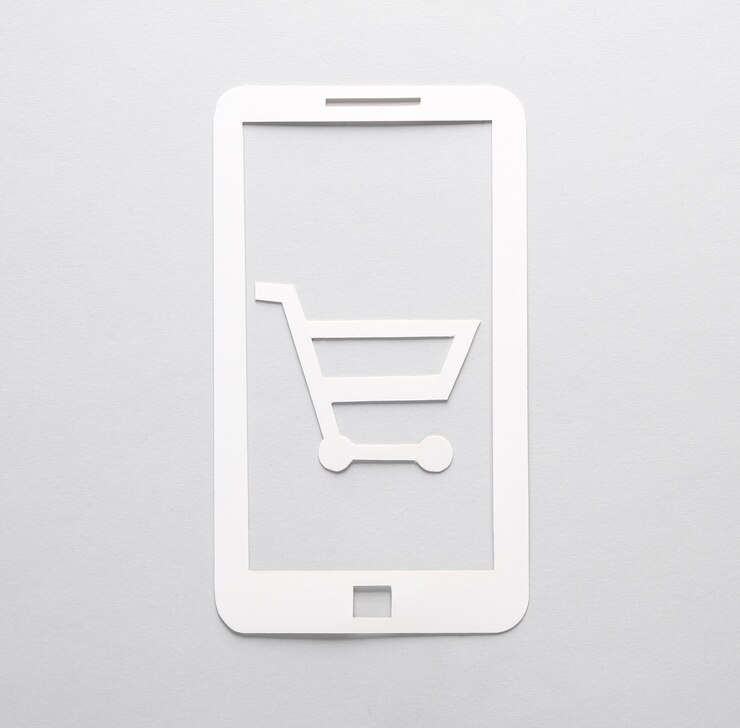 Foto smartphone de corte de papel con un carrito de compras en un fondo gris compras en línea