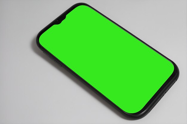 Smartphone deitado com ecrã verde em fundo branco