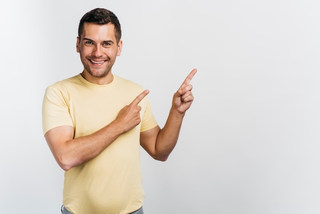 Foto smileymann, der in einen richtungskopienraum zeigt