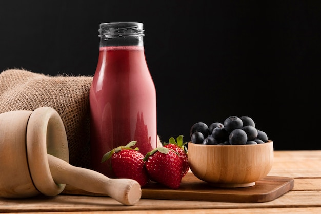 Smoothie de vista frontal com morangos e mirtilos
