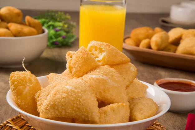 Snack brasileño, con una barra de fondo. Pastelería de queso sobre fondo de madera.