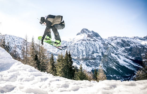 Snoboarder, der Tricks auf dem Schnee ausführt