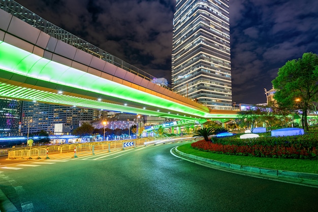 Sob a ponte pedonal da paisagem urbana de Xangai à noite, China