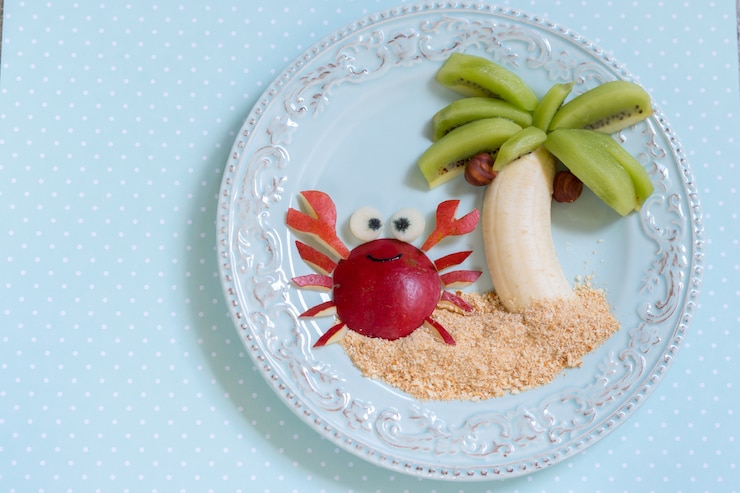 Foto sobremesa de frutas para criança criança com kiwi, banana e pêra
