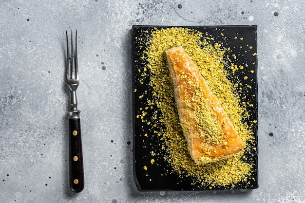 Sobremesa turca Havuc Dilim Baklava com pistache e mel Fundo cinza Vista superior