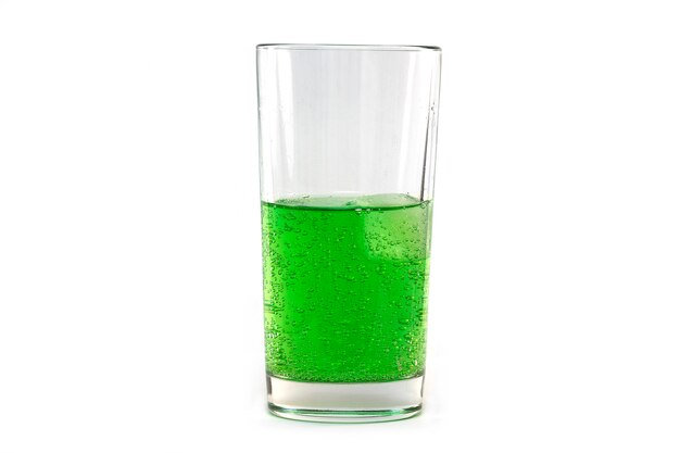 Soda espumante verde natural em vidro com gelo isolado no branco