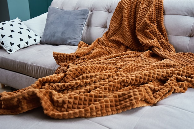 Foto sofa mit plaid und tasse tee. platz zum entspannen