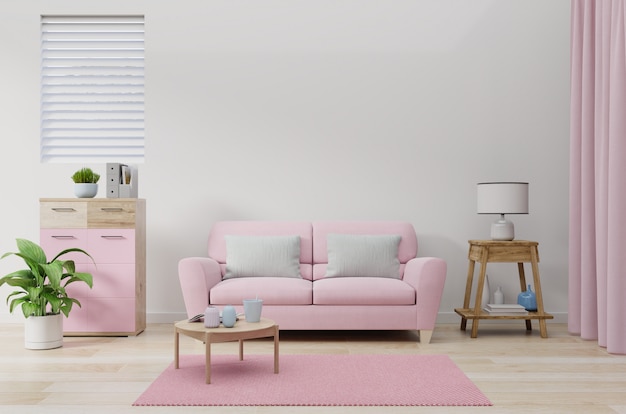 El sofá rosa en la pared de la sala de color blanco.