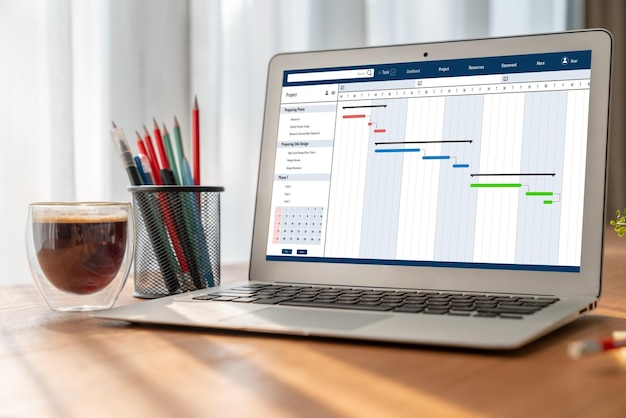 Foto software de planificación de proyectos para la gestión de proyectos empresariales modish en la pantalla de la computadora que muestra el gráfico de línea de tiempo del proyecto del equipo