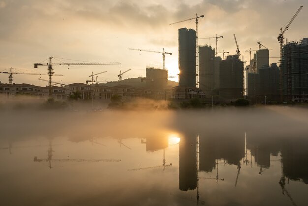 Foto el sol brillaba en el sitio de construcción del río brumoso, que reflejaba los altos edificios