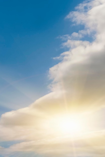 Sol brillante en el cielo azul con fondo de nubes esponjosas blancas