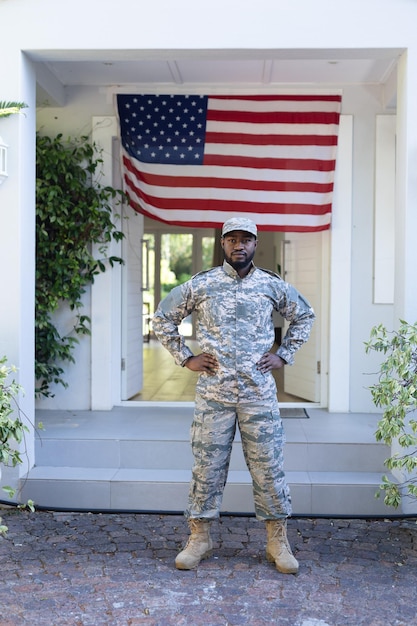 Foto soldado afro-americano em frente à bandeira americana fora de casa