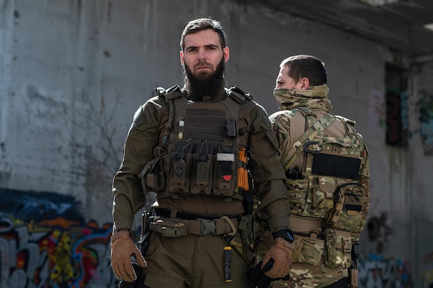 Soldados de guerra moderna no escuro com munições de combate e armas nas mãos de visores a laser equipados estão em ordem de batalha.