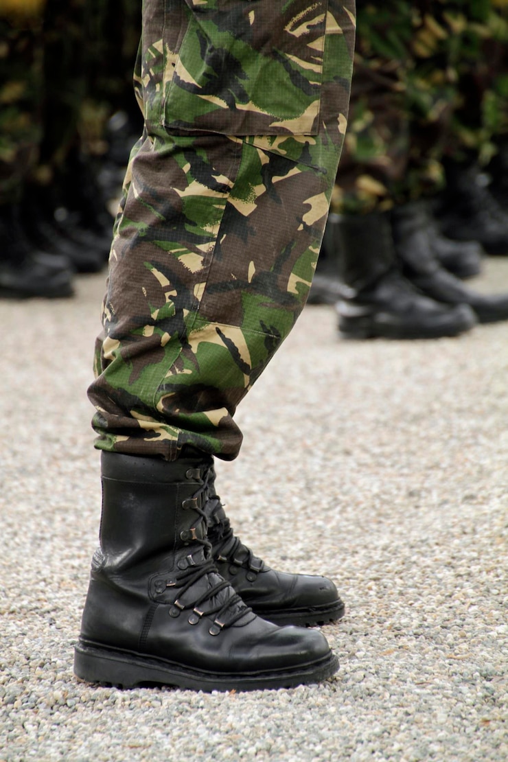 Foto soldados em um desfile militar com botas e roupas de camuflagem