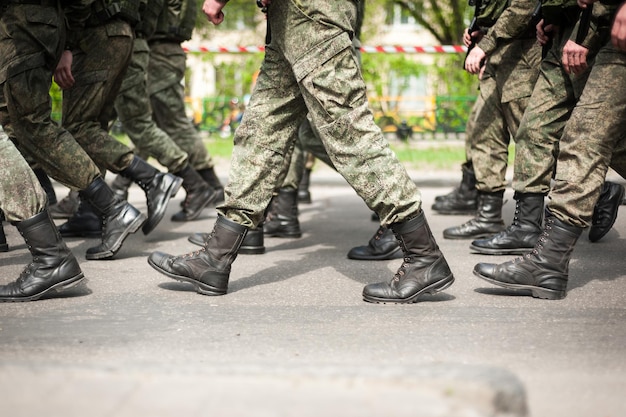 Soldados marchando con botas militaresxA