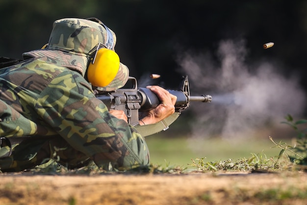 Soldat schießt Gewehrgewehr, um mit Kugelpatrone in der Luft zu zielen