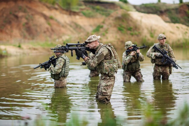 Soldaten der Spezialeinheiten mit Waffen nehmen an Militärmanöver-Kriegsarmeetechnologie und Menschenkonzept teil