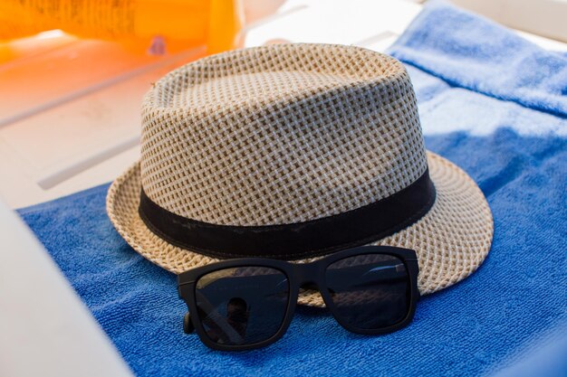 Foto sombrero de playa para hombre en tumbona