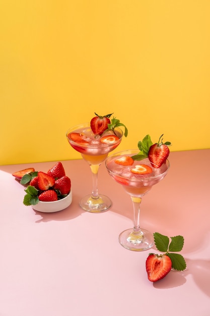 Sommer-Mojito-Cocktail mit Erdbeeren auf gelbem Hintergrund. Erdbeer-Mojito. Erfrischendes Sommergetränk mit Kopienraum