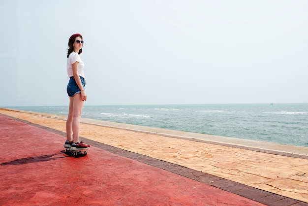 Sommer-Strandurlaub-Konzept des Skateboard-entspannenden Verfolgungs