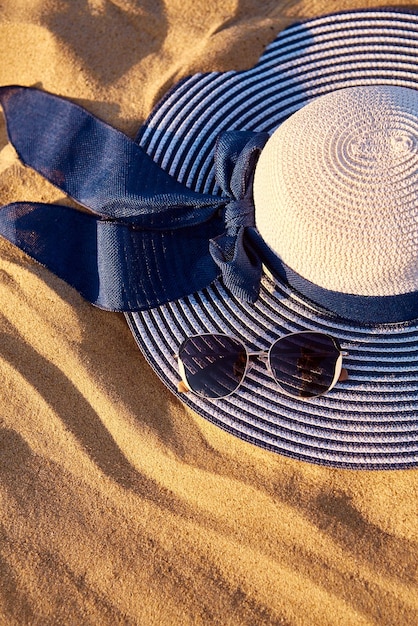 Sommerhut mit Sonnenbrille am Strand