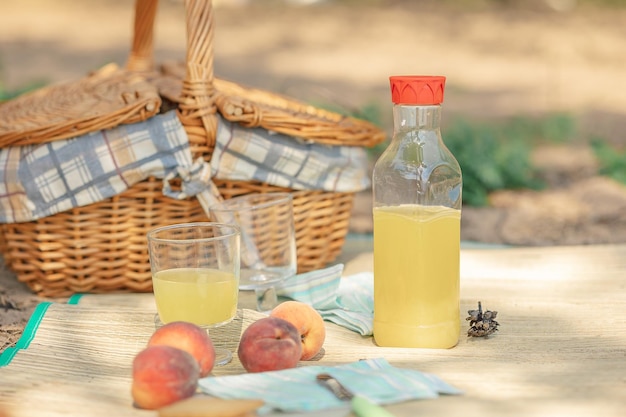 Sommerpicknick am Strand auf dem Seeweg Kekse mit frischen Früchten und Pfirsiche in der Nähe von Picknickkorb auf Stoff